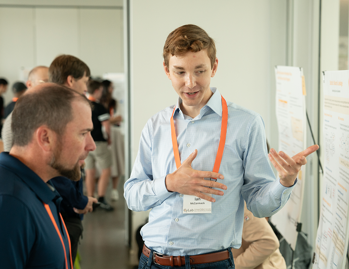 Photo of Ian McCormack presenting his research poster at the CyLab Partners Conference