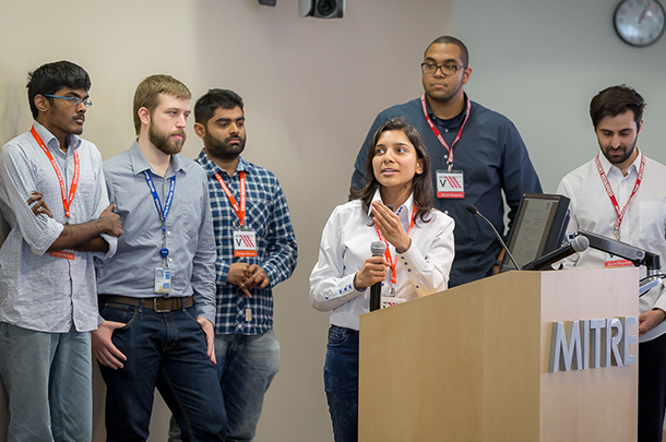 Team standing at podium, presenting project