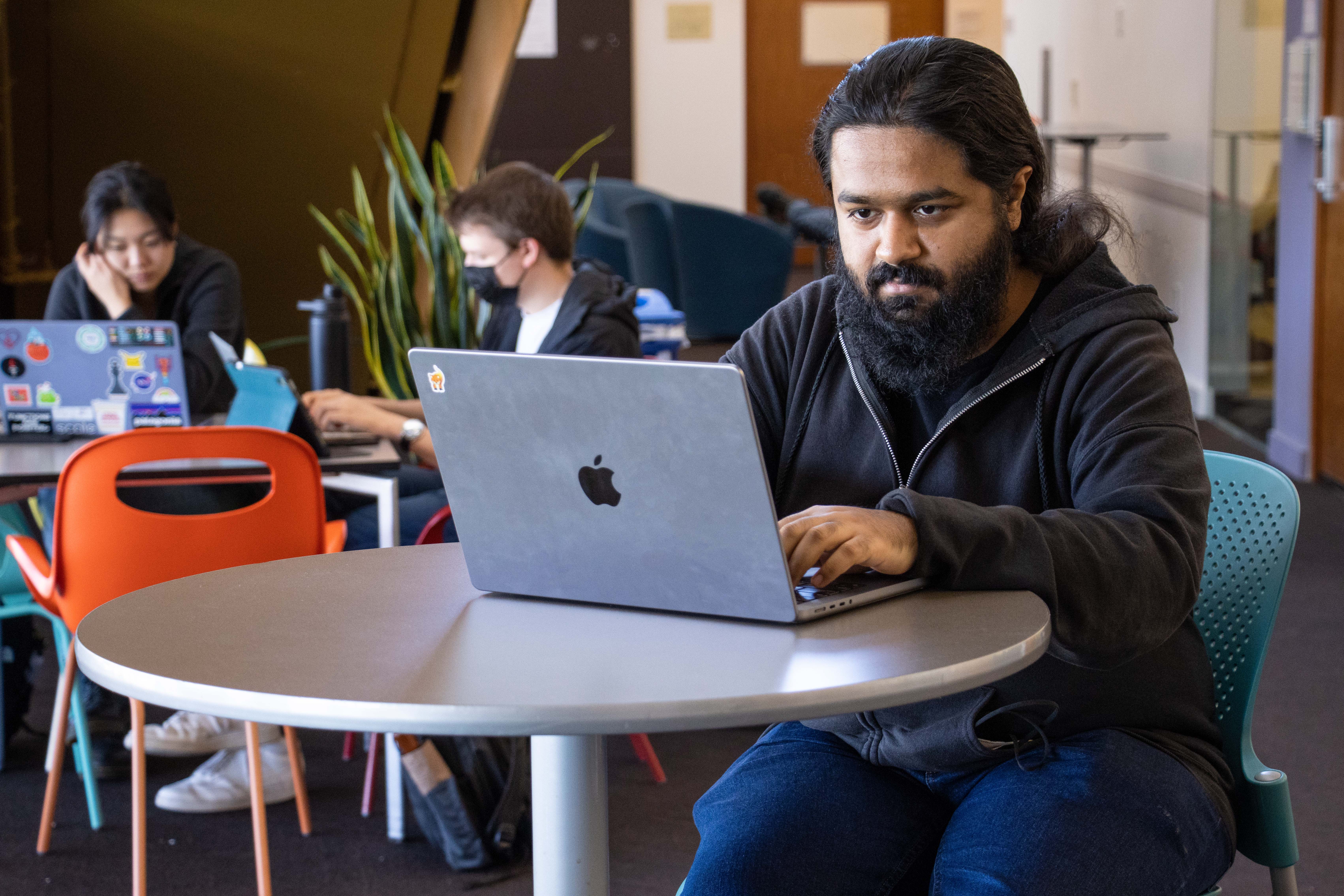 Jay Bosamiya works on his computer in the Gates Hillman building on Carnegie Mellon's Pittsburgh campus