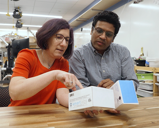 two people looking at boxes together